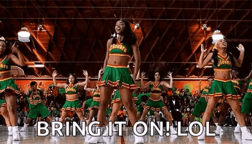 A Group Of Cheerleaders Are Dancing On A Basketball Court In Front Of A Crowd Of People . GIF