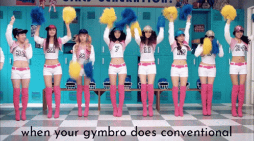 A Group Of Cheerleaders Are Holding Up Pom Poms In Front Of Lockers GIF
