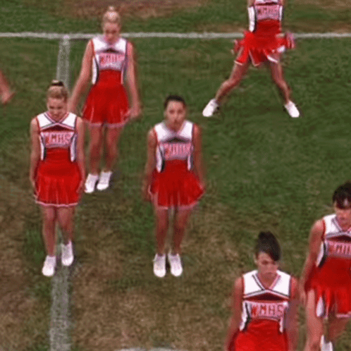 A Group Of Cheerleaders Are Performing A Dance On A Field . GIF