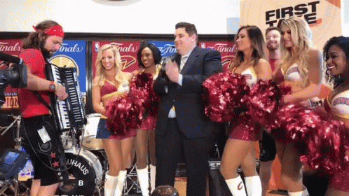 A Group Of Cheerleaders Are Standing In Front Of A Drum That Says Bauhaus GIF