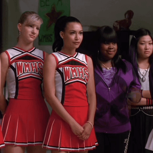 A Group Of Cheerleaders Wearing Wmhs Uniforms Are Standing Next To Each Other GIF