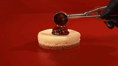 A Group Of Cheesecakes With Whipped Cream And Jelly On Top GIF
