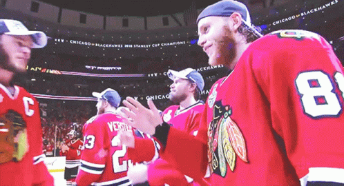 A Group Of Chicago Blackhawks Players Standing Together GIF