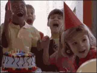 A Group Of Children Are Celebrating A Birthday With A Birthday Cake . GIF