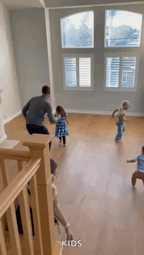 A Group Of Children Are Playing In A Living Room . GIF