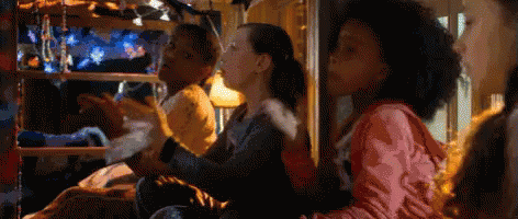 A Group Of Children Are Sitting In A Bunk Bed Playing A Video Game . GIF