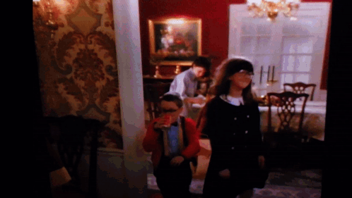 A Group Of Children Are Standing In A Room GIF