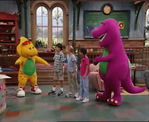 A Group Of Children Standing Around A Purple And Yellow Dinosaur GIF