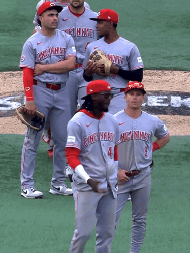 A Group Of Cincinnati Baseball Players Stand On A Field GIF