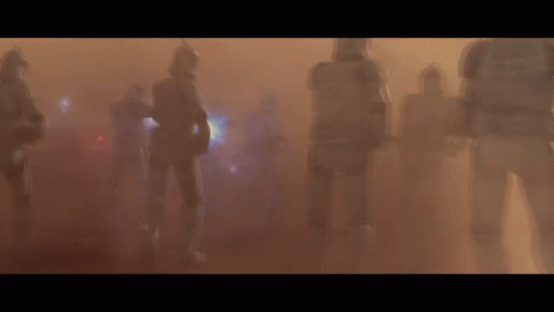 A Group Of Clone Troopers Are Walking Through A Foggy Field GIF