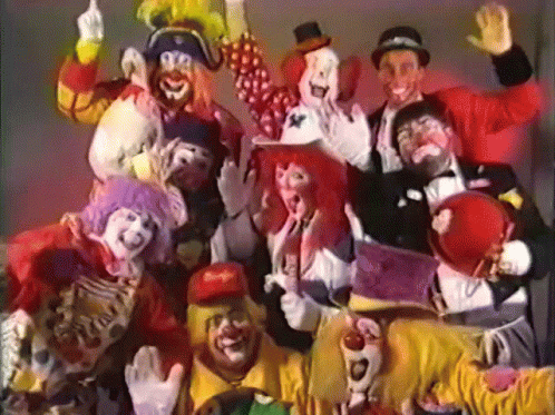 A Group Of Clowns Are Posing For A Photo And One Has A Mcdonald 'S Hat On GIF