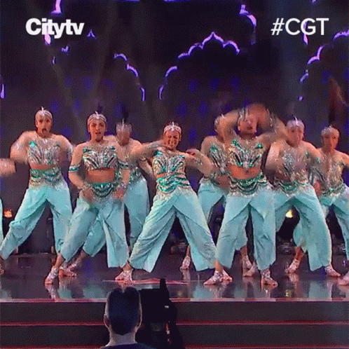 A Group Of Dancers Are Performing On A Stage With The Words Citytv Behind Them GIF