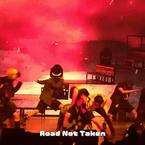 A Group Of Dancers On A Stage With The Words Road Not Taken GIF