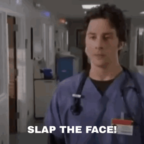 A Group Of Doctors And Nurses Are Standing In A Hospital Room And A Man Is Saying Slap The Face . GIF