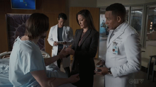 A Group Of Doctors Are Talking To A Patient In A Hospital Room With Ctv Written On The Bottom Of The Screen GIF