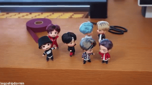 A Group Of Dolls Are Standing On A Wooden Table With The Hashtag Bogoshipdarmin GIF
