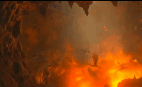 A Group Of Dragons Are Flying Through A Cave Filled With Flames And Smoke . GIF