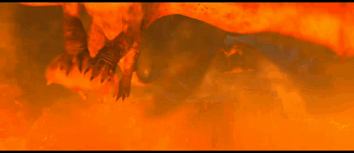 A Group Of Dragons Are Flying Through A Fire Filled Area GIF