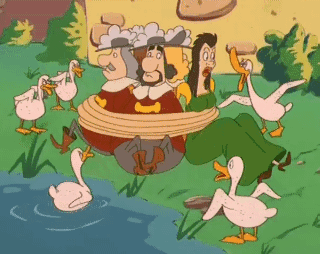 A Group Of Ducks Are Surrounding A Group Of People Tied Up GIF