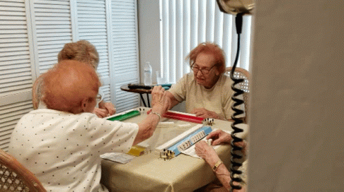 A Group Of Elderly People Are Playing Mahjong GIF