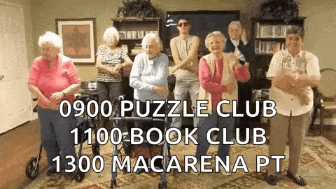 A Group Of Elderly People Are Standing In A Room . GIF