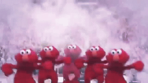 A Group Of Elmo Stuffed Animals Are Standing Next To Each Other . GIF