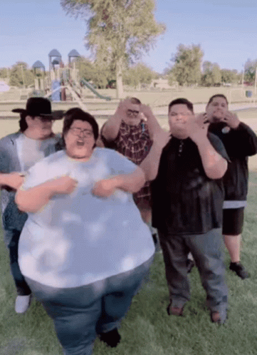 A Group Of Fat People Are Posing For A Picture GIF