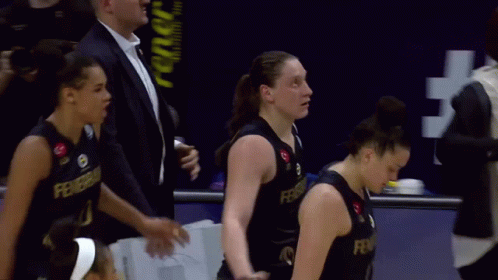A Group Of Female Basketball Players Are Standing In Front Of A Sign That Says #Fear GIF
