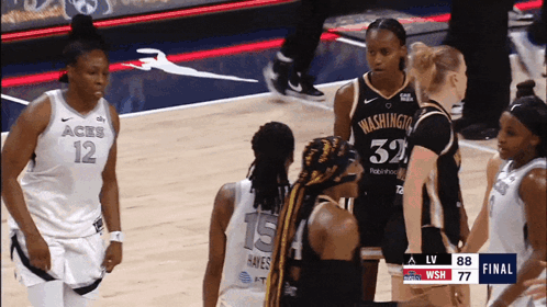 A Group Of Female Basketball Players Are Standing On A Court With One Wearing A Jersey That Says Washington GIF