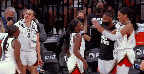 A Group Of Female Basketball Players Are Standing On The Court And One Of Them Is Wearing A Black Shirt That Says Lives GIF