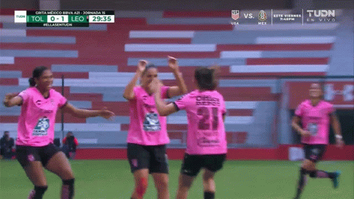 A Group Of Female Soccer Players Are Celebrating A Goal Against Leo GIF