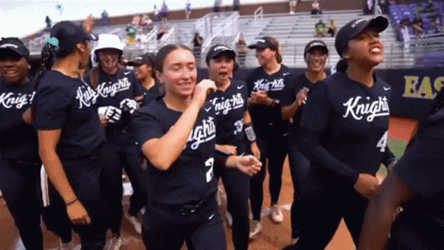 a group of female softball players wearing shirts that say knights on them