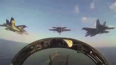 A Group Of Fighter Jets Are Flying In Formation In The Sky GIF