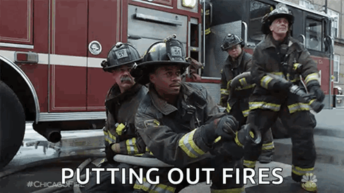 A Group Of Firefighters Are Putting Out A Fire . GIF