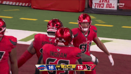 A Group Of Football Players Are Hugging Each Other On The Field And One Of Them Has The Name Ingram On His Back GIF
