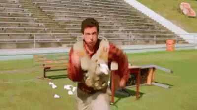 A Group Of Football Players Are Lined Up On The Field . GIF