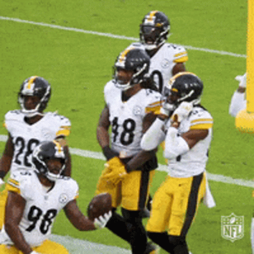 A Group Of Football Players Are On A Field With One Wearing A Number 98 Jersey GIF