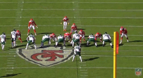 A Group Of Football Players Are On A Field With The Number 14 In The Foreground GIF