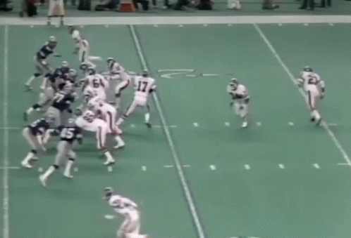 A Group Of Football Players Are Playing A Game On A Field And One Of Them Has The Number 60 On His Jersey GIF