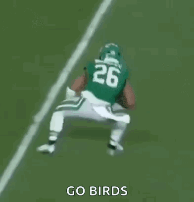 A Group Of Football Players Are Playing A Game On A Field And One Of Them Is Wearing A Number 23 Jersey . GIF