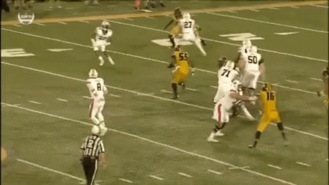 A Group Of Football Players Are Playing A Game On A Field . One Of The Players Has The Number 78 On His Jersey . GIF