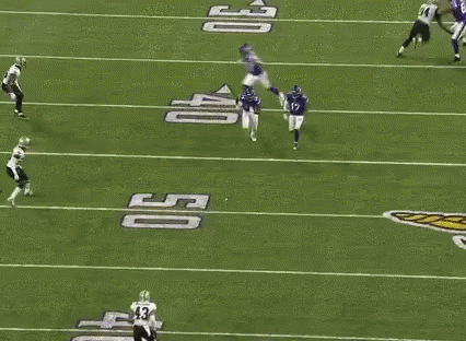A Group Of Football Players Are Playing On A Field . One Of The Players Has The Number 14 On His Jersey . GIF