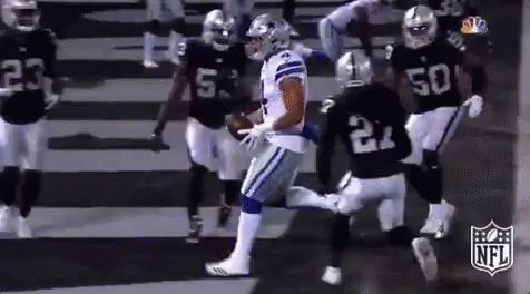 A Group Of Football Players Are Running On A Field . One Of The Players Has The Number 21 On His Jersey . GIF