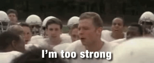 A Group Of Football Players Are Standing In A Huddle And A Man Is Standing In The Middle Of The Group . GIF