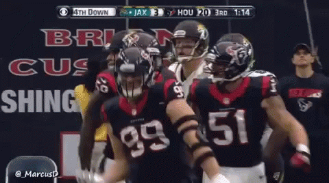 A Group Of Football Players Are Standing In Front Of A Sign That Says ' Brig Cus Shing ' GIF