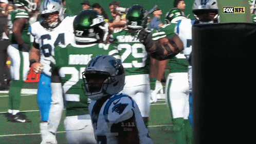 A Group Of Football Players Are Standing On A Field And One Of Them Has The Number 29 On His Jersey GIF
