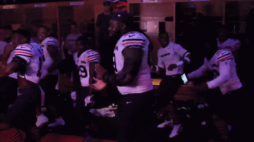 A Group Of Football Players Including Number 55 And Number 29 GIF
