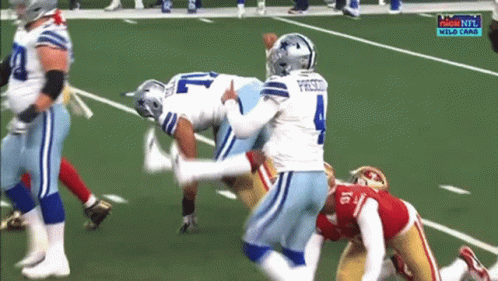 A Group Of Football Players On A Field With The Number 4 On The Jersey GIF