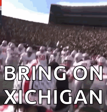 A Group Of Football Players Standing In A Stadium With The Words Bring On Michigan Written On The Screen GIF