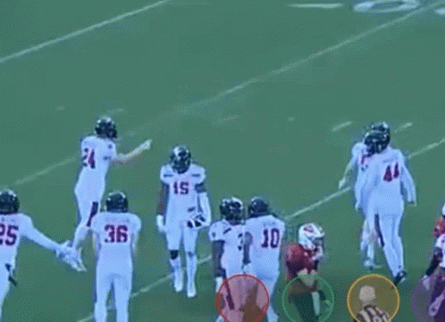 A Group Of Football Players Standing On A Field . GIF